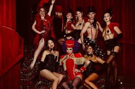 Burlesque performers gathered on the stairs at Bristol 2025
